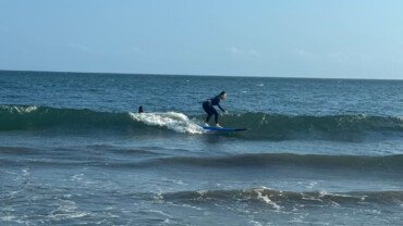 Intermediate surfer girl on a surfboard at Berawa Beach, Bali